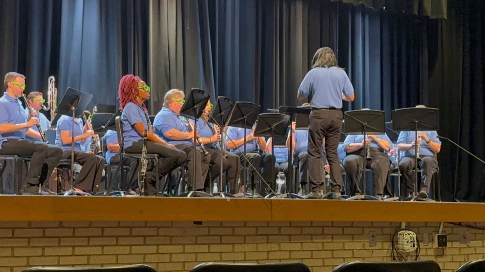 Members of the Clarinet Choir performing in matching green sunglasses